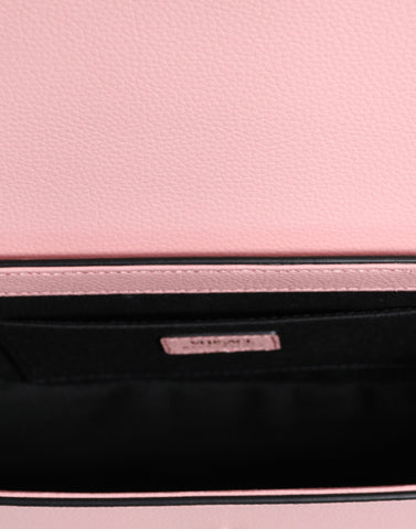 Pink grainy calf leather Versace logo crossbody shoulder bag with adjustable strap and silver hardware.