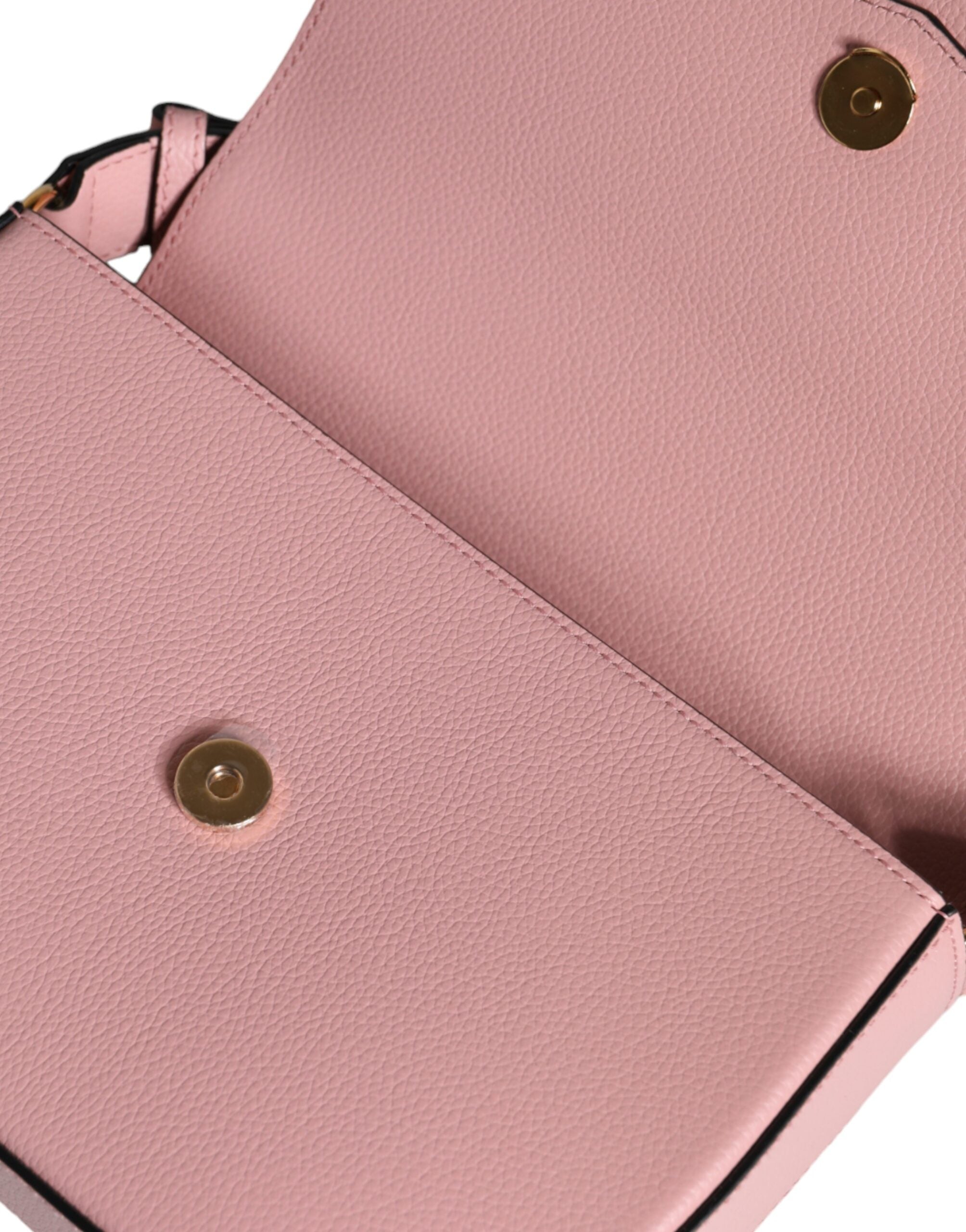Pink grainy calf leather Versace logo crossbody shoulder bag with adjustable strap and gold-tone hardware.