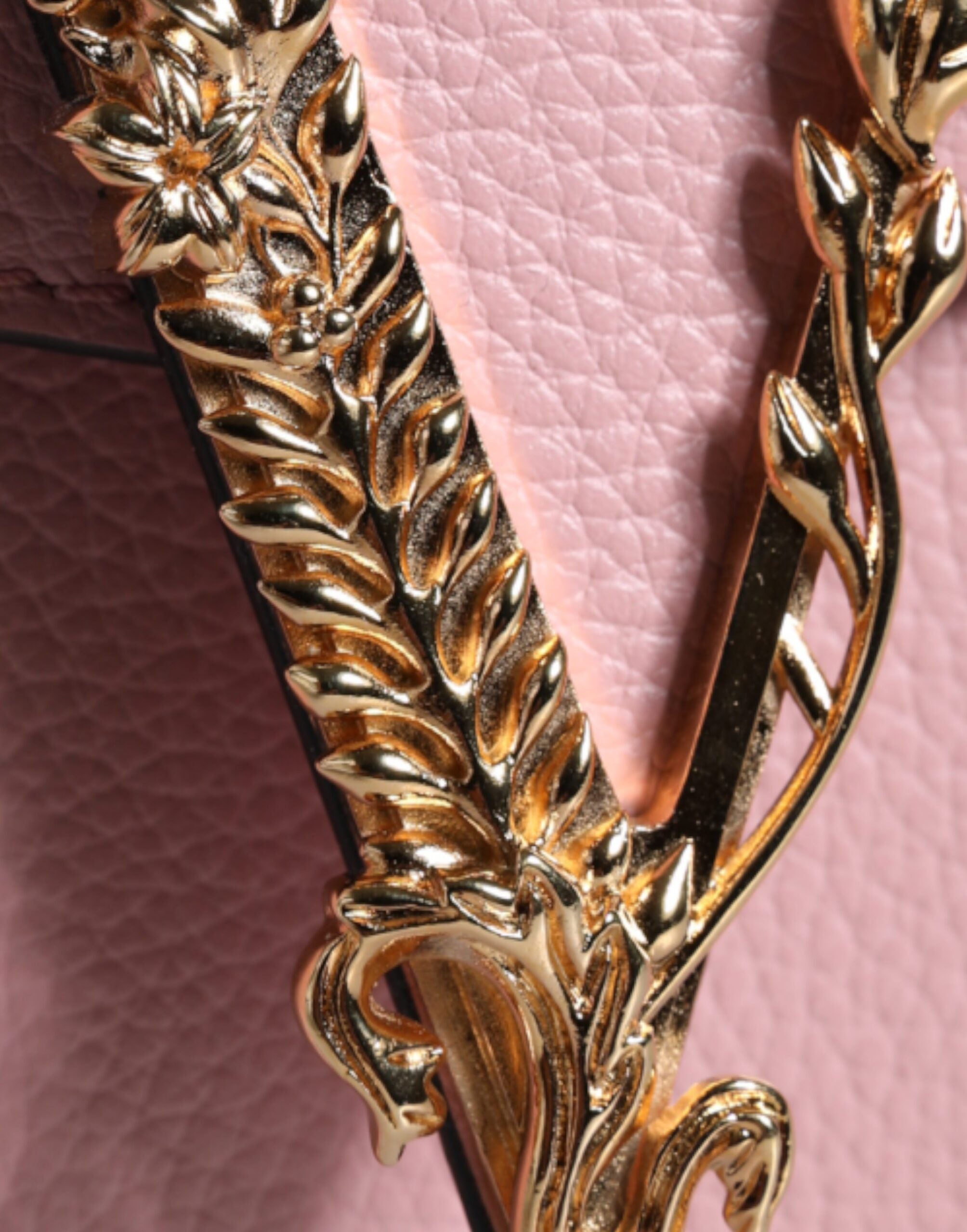 Pink grainy calf leather Versace logo crossbody shoulder bag with adjustable strap and gold-tone hardware.