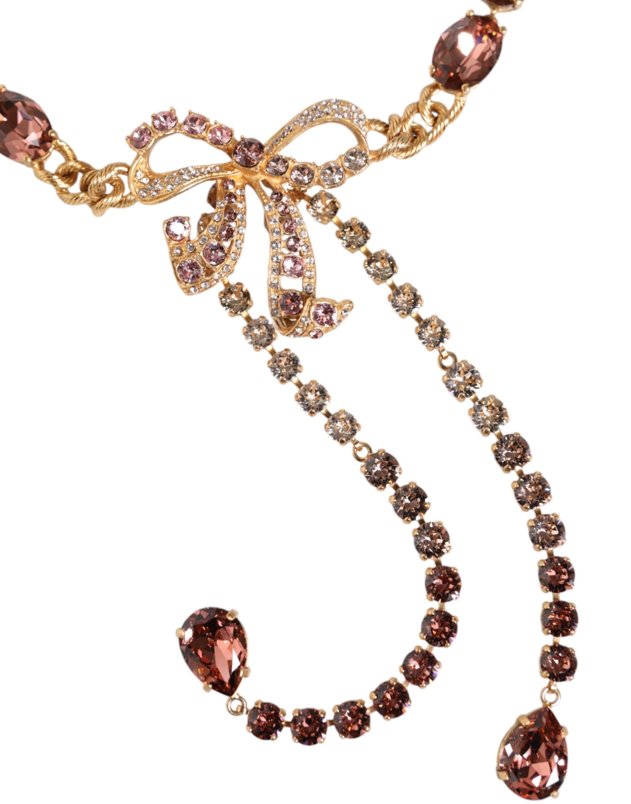 Gold tone brass belt with crystal embellishments from Dolce & Gabbana, featuring intricate detailing and elegant design.