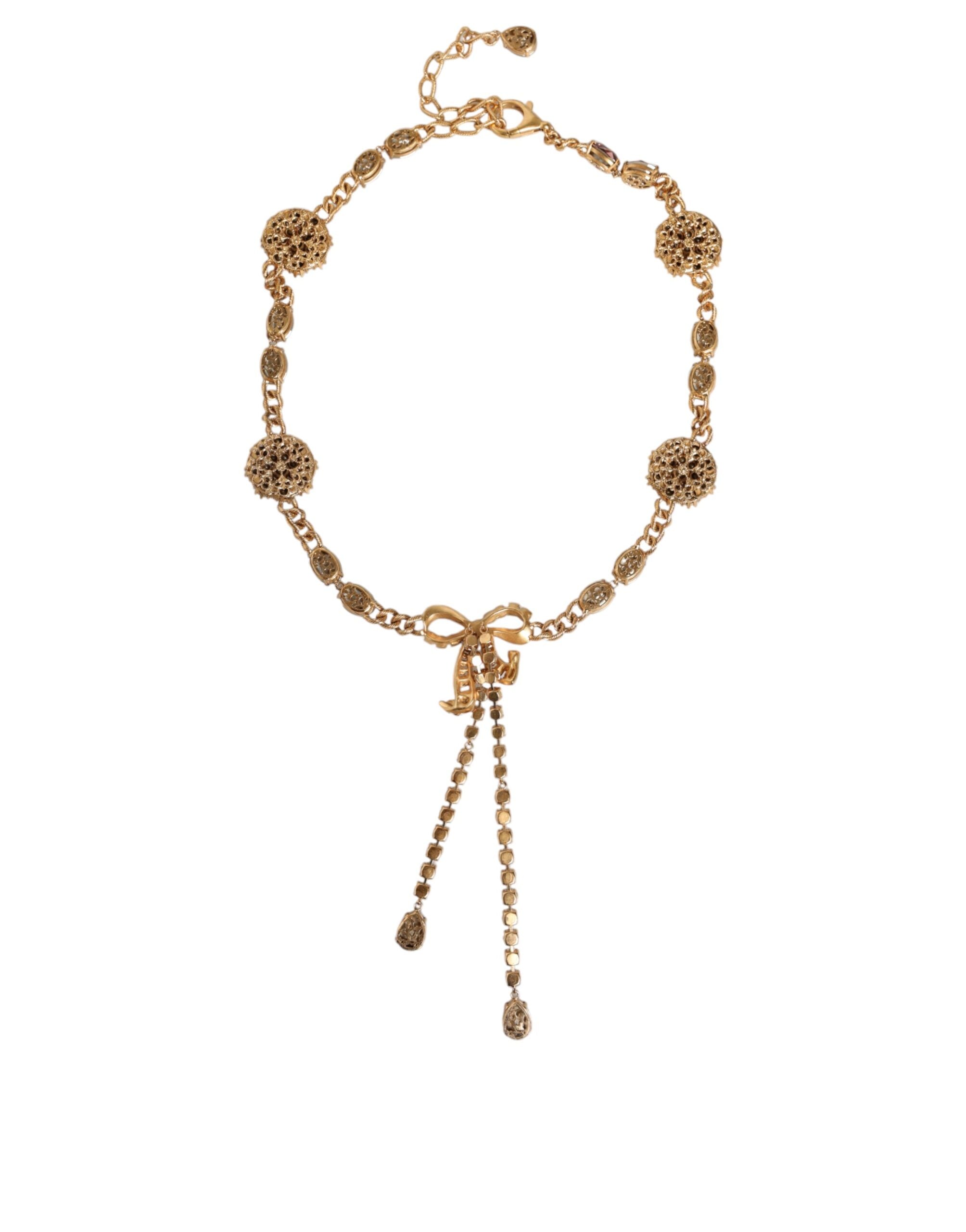Gold tone brass belt with crystal embellishments by Dolce & Gabbana, featuring intricate detailing and a luxurious finish.