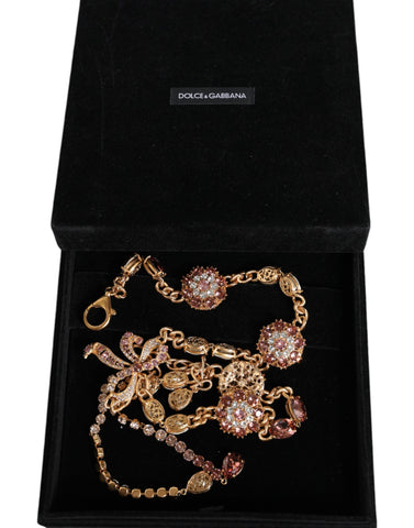 Gold tone brass belt with crystal embellishments from Dolce & Gabbana, showcasing intricate detailing and luxurious design.
