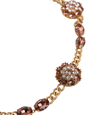 Gold tone brass waist chain belt with crystal embellishments by Dolce & Gabbana, featuring intricate detailing and a luxurious finish.