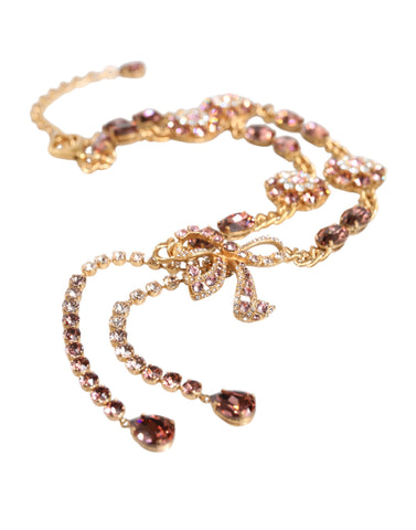 Gold tone brass waist chain belt with crystal embellishments, designed by Dolce & Gabbana, featuring intricate detailing and luxurious style.