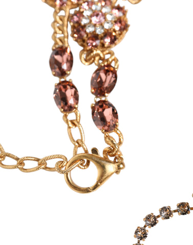 Gold tone brass waist chain belt with crystal embellishments, stylish accessory by Dolce & Gabbana, shown on a neutral background.