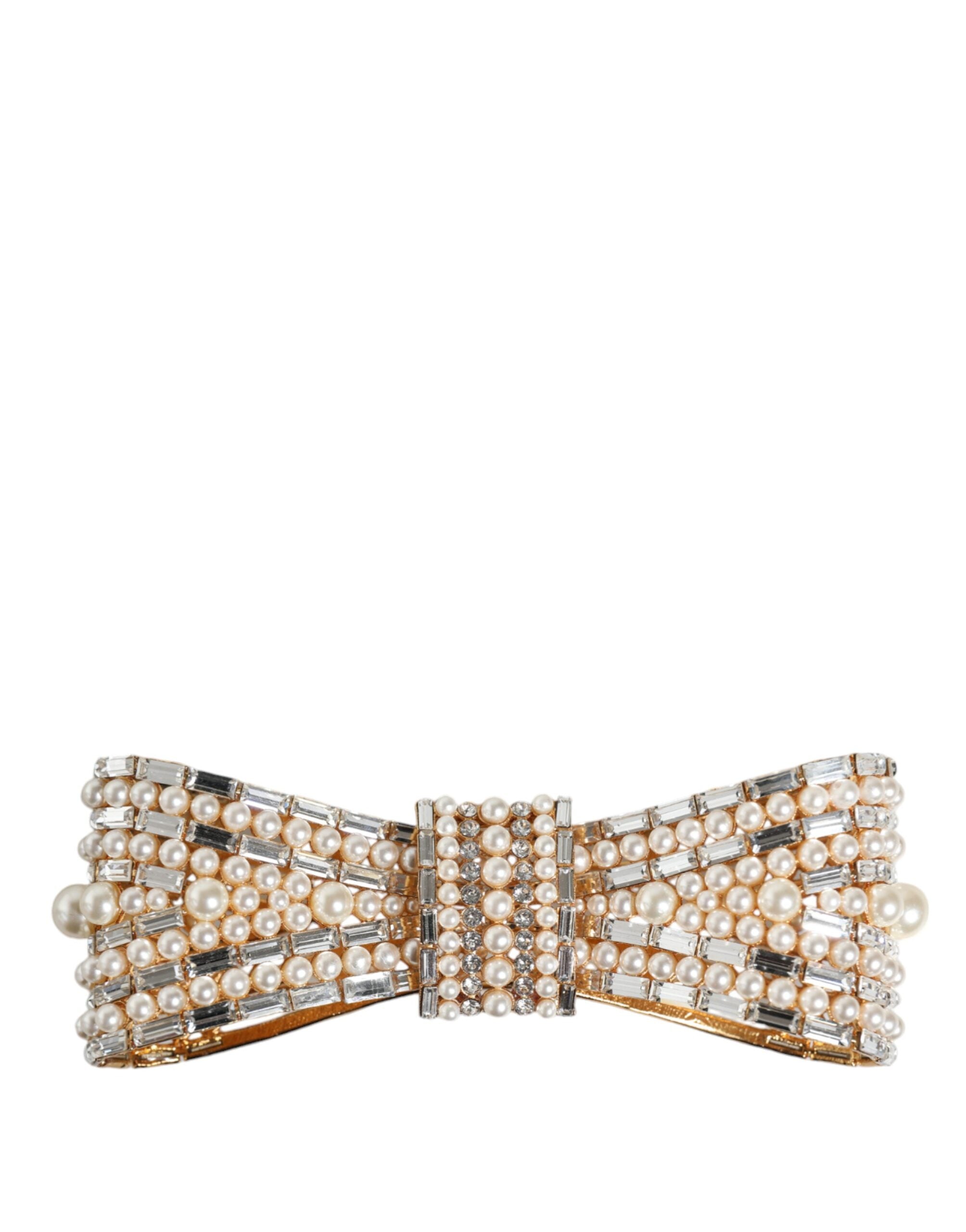 Gold tone brass bow brooch with crystal accents and faux pearl embellishments, elegant accessory by Dolce & Gabbana.