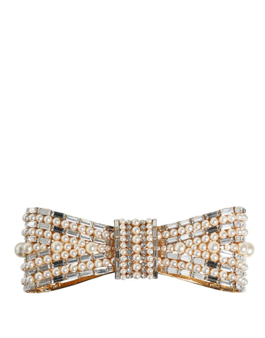Gold tone brass bow brooch with crystal accents and faux pearl embellishments, elegant accessory by Dolce & Gabbana.