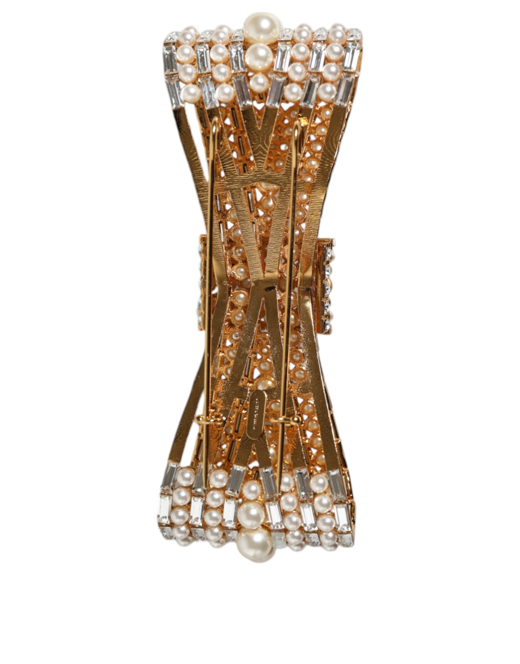 Gold tone brass bow brooch with crystal accents and faux pearl embellishments, designed by Dolce & Gabbana.