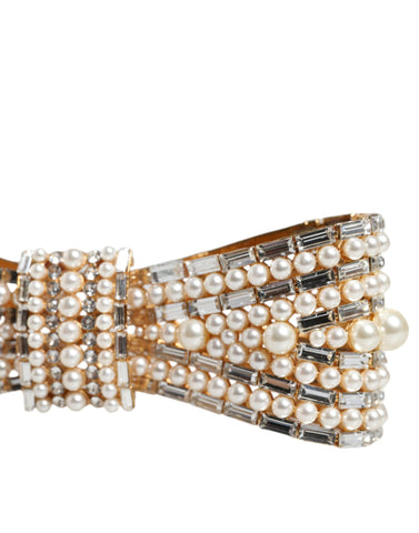 Gold tone brass bow brooch with crystal accents and faux pearl embellishments, designed by Dolce & Gabbana.