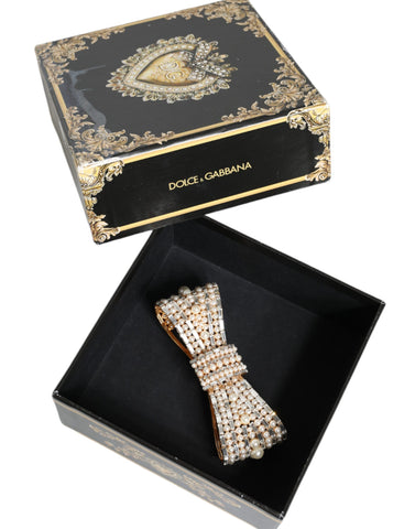 Gold tone brass bow brooch with crystal accents and faux pearl embellishments, designed by Dolce & Gabbana.