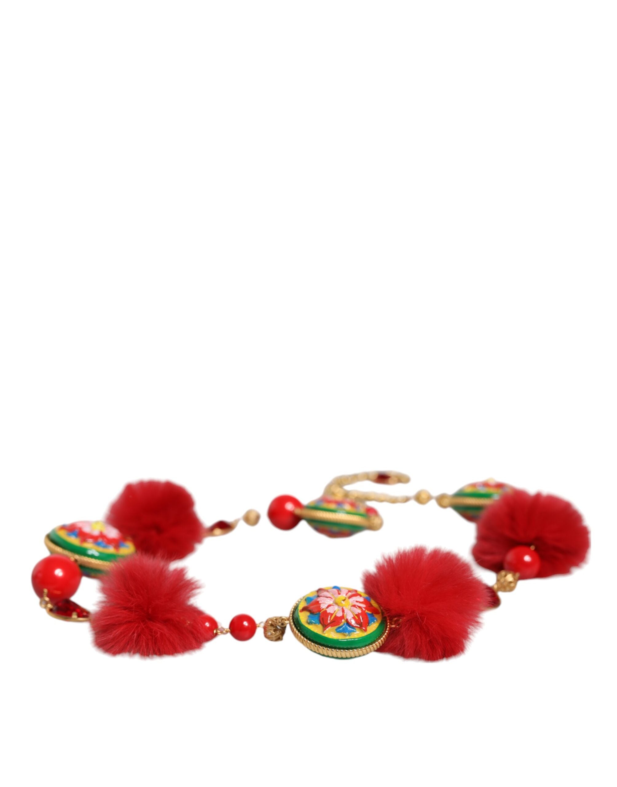Gold brass waist belt with red fur and crystal details, designed by Dolce & Gabbana, featuring a torero-inspired style.