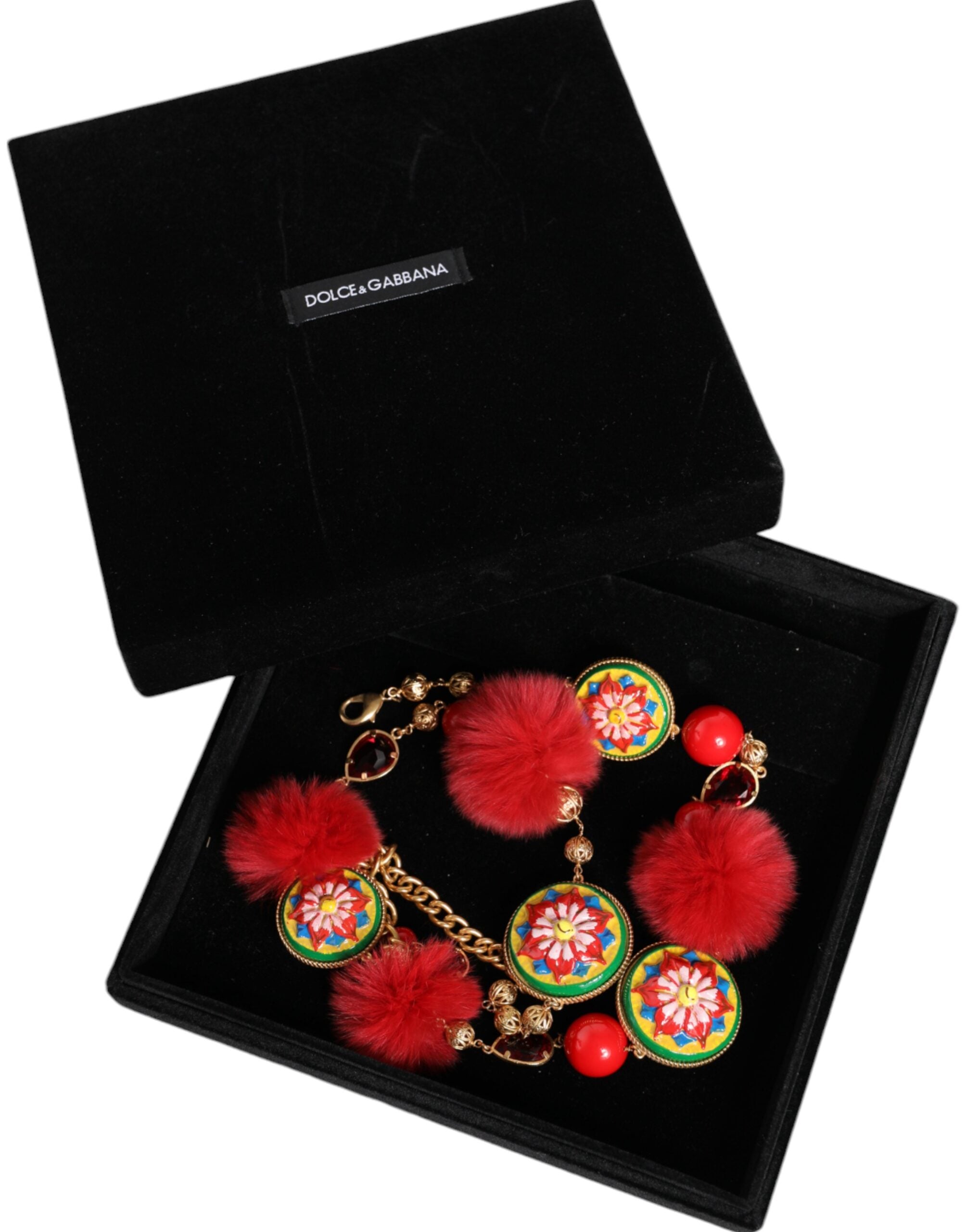 Gold brass waist belt with red fur and crystal accents by Dolce & Gabbana, featuring a torero-inspired design.