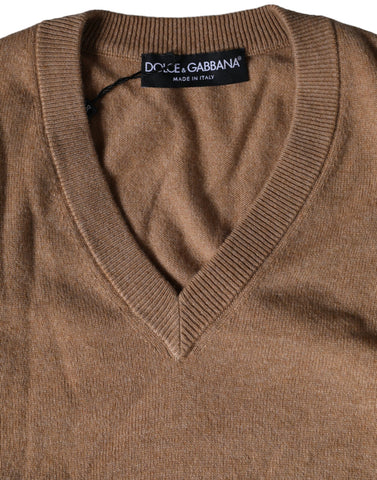 Brown cashmere knit V-neck pullover sweater by Dolce & Gabbana, shown on a hanger with a textured background.