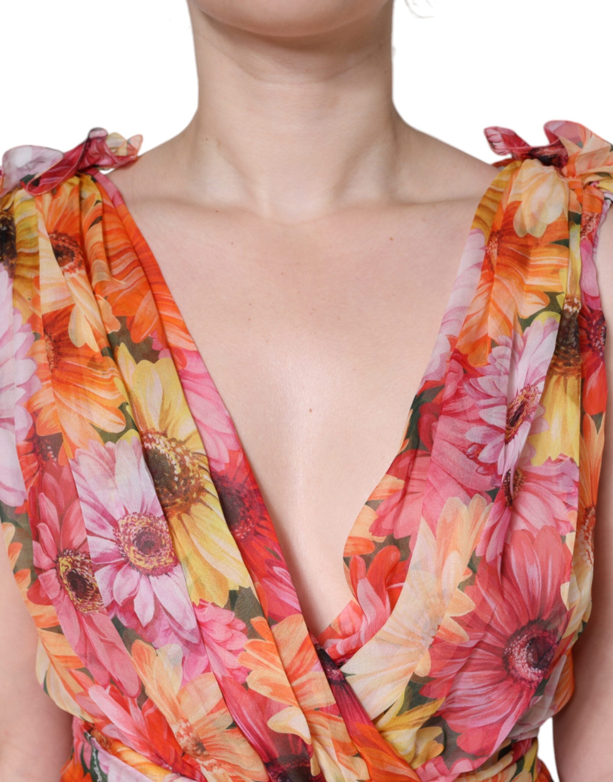 Dolce & Gabbana multicolor floral sleeveless V-neck midi dress displayed on a hanger with vibrant floral pattern.