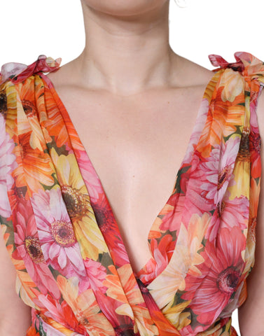 Dolce & Gabbana multicolor floral sleeveless V-neck midi dress displayed on a hanger with vibrant floral pattern.
