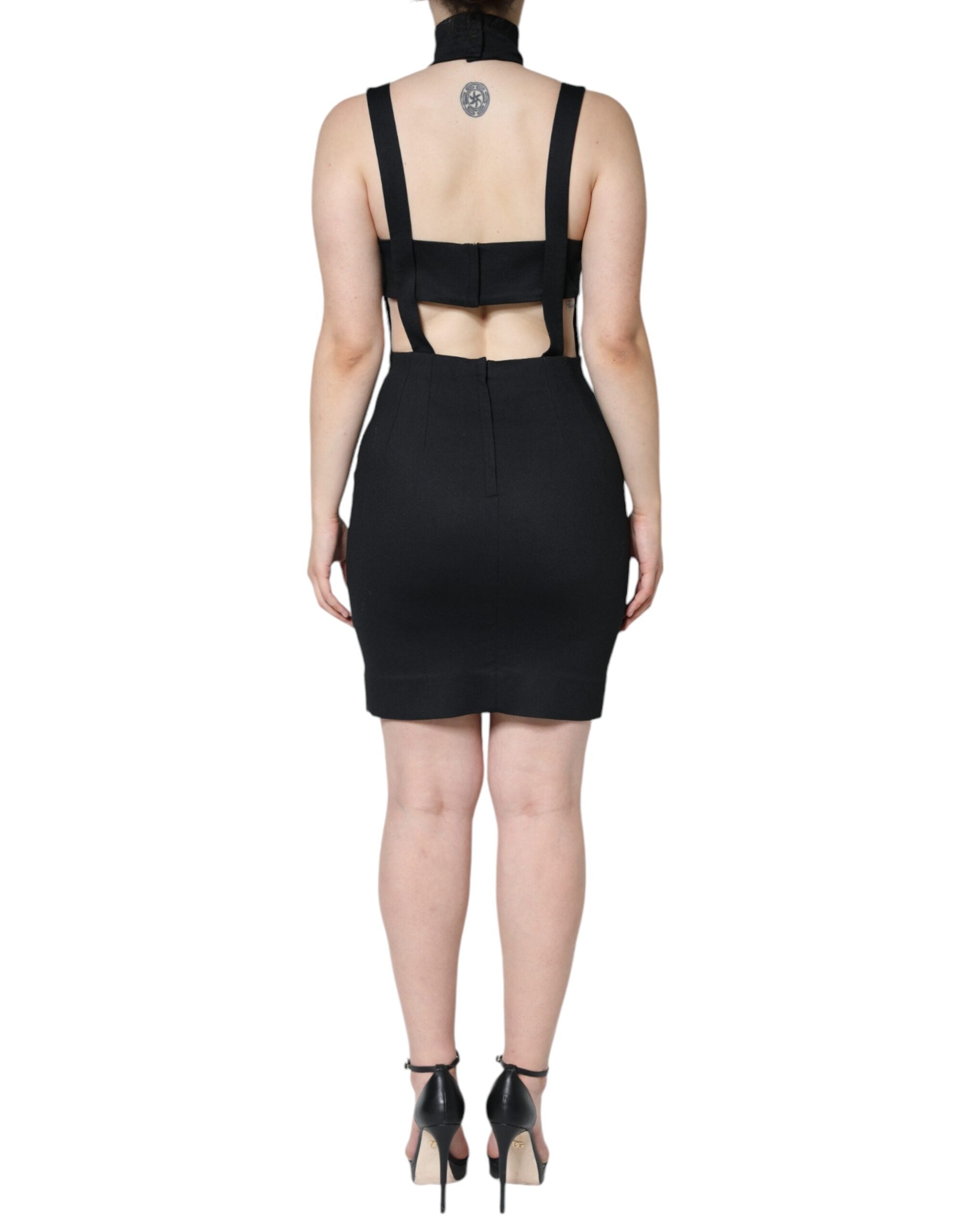 Black cut-out sleeveless bodycon mini dress by Dolce & Gabbana, shown on a model with a fitted silhouette and stylish design.