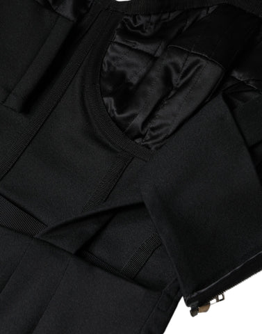 Black cut-out sleeveless bodycon mini dress by Dolce & Gabbana, shown on a model with a fitted silhouette and bold design details.