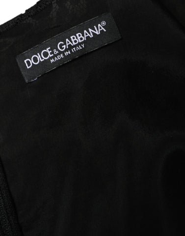 Black floral lace sheath sleeveless mini dress by Dolce & Gabbana displayed on a hanger with intricate lace details.