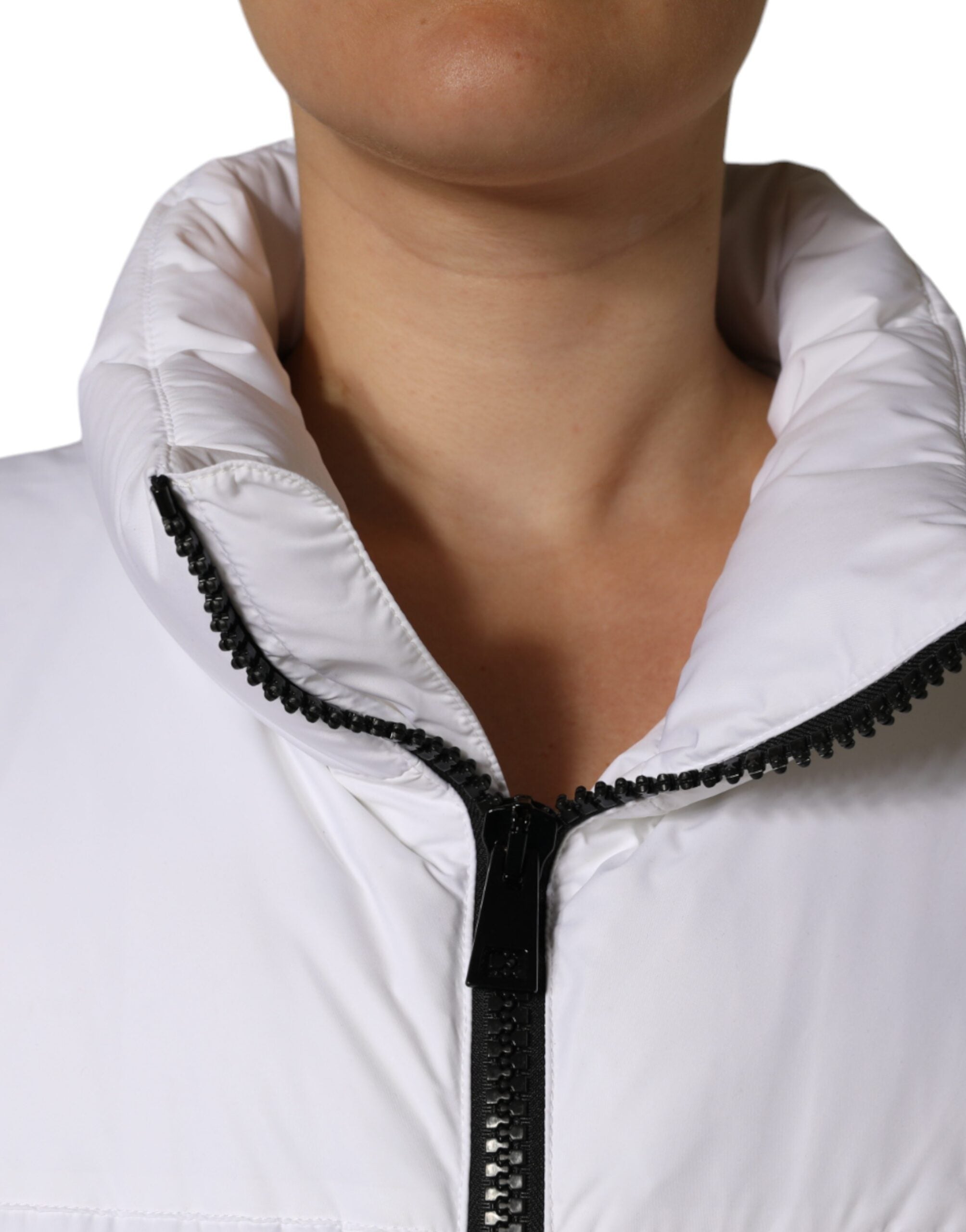 White puffer quilted full zip coat jacket by Dolce & Gabbana, shown hanging with a high collar and padded design.