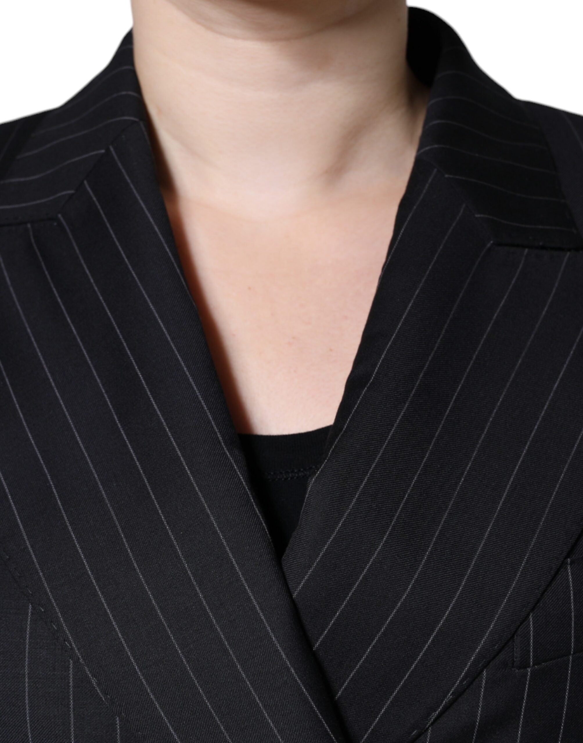 Black striped double-breasted coat jacket by Dolce & Gabbana, shown on a hanger with front view and classic lapel design.