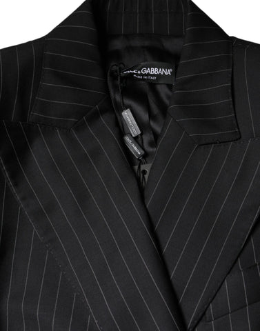 Black striped double-breasted coat jacket by Dolce & Gabbana hanging on a rack with buttons and tailored fit.
