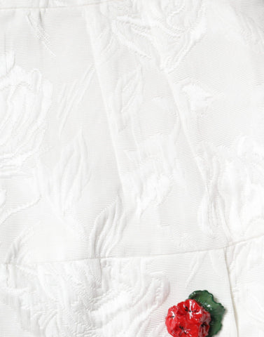 White floral brocade mini skirt with embellishments by Dolce & Gabbana, featuring intricate embroidery and a fitted silhouette.