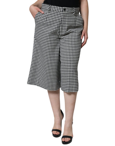 Black and white houndstooth cropped wide-leg pants by Dolce & Gabbana, featuring a stylish, tailored design.