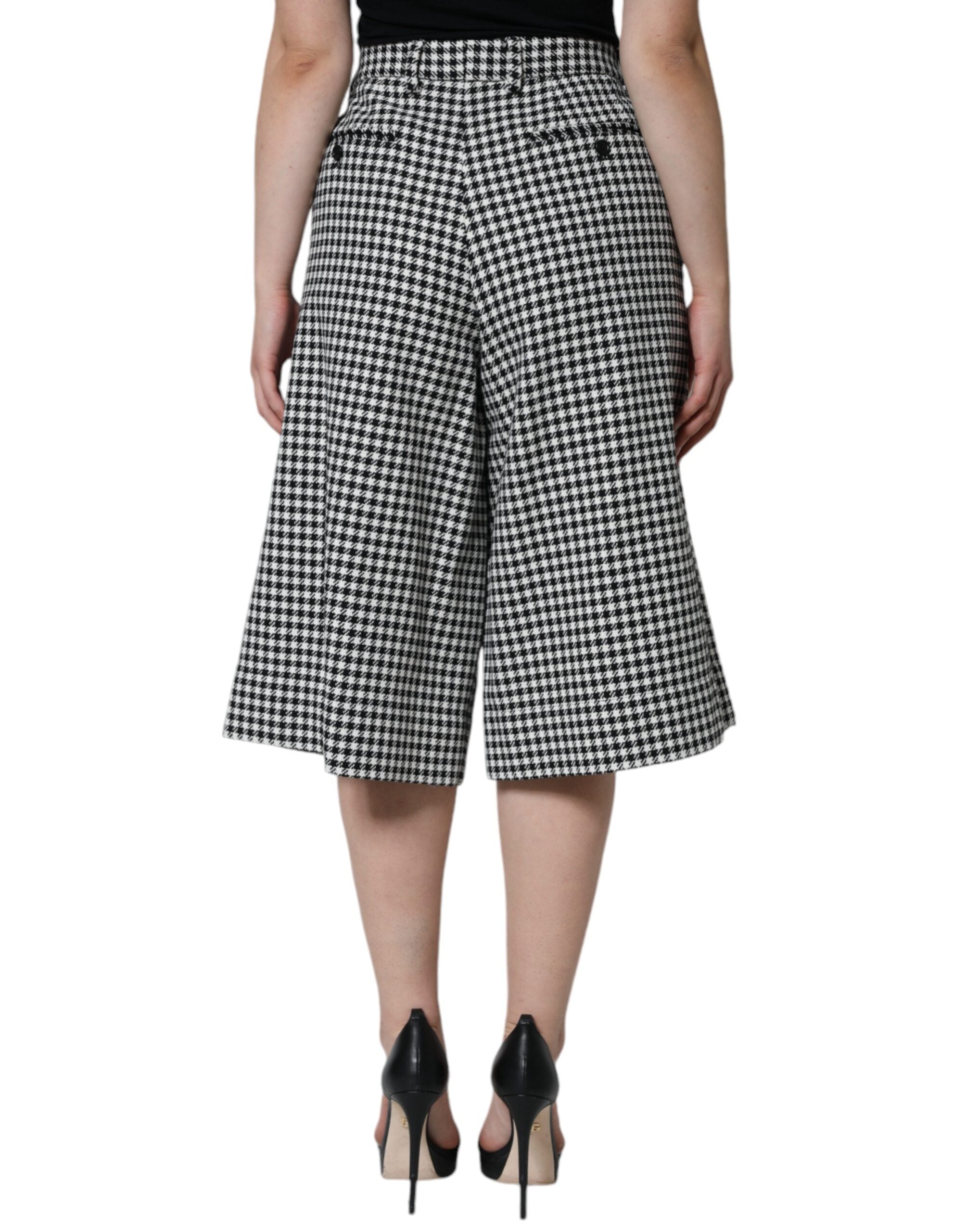Black and white houndstooth cropped wide-leg pants by Dolce & Gabbana, featuring a stylish high-waisted design.