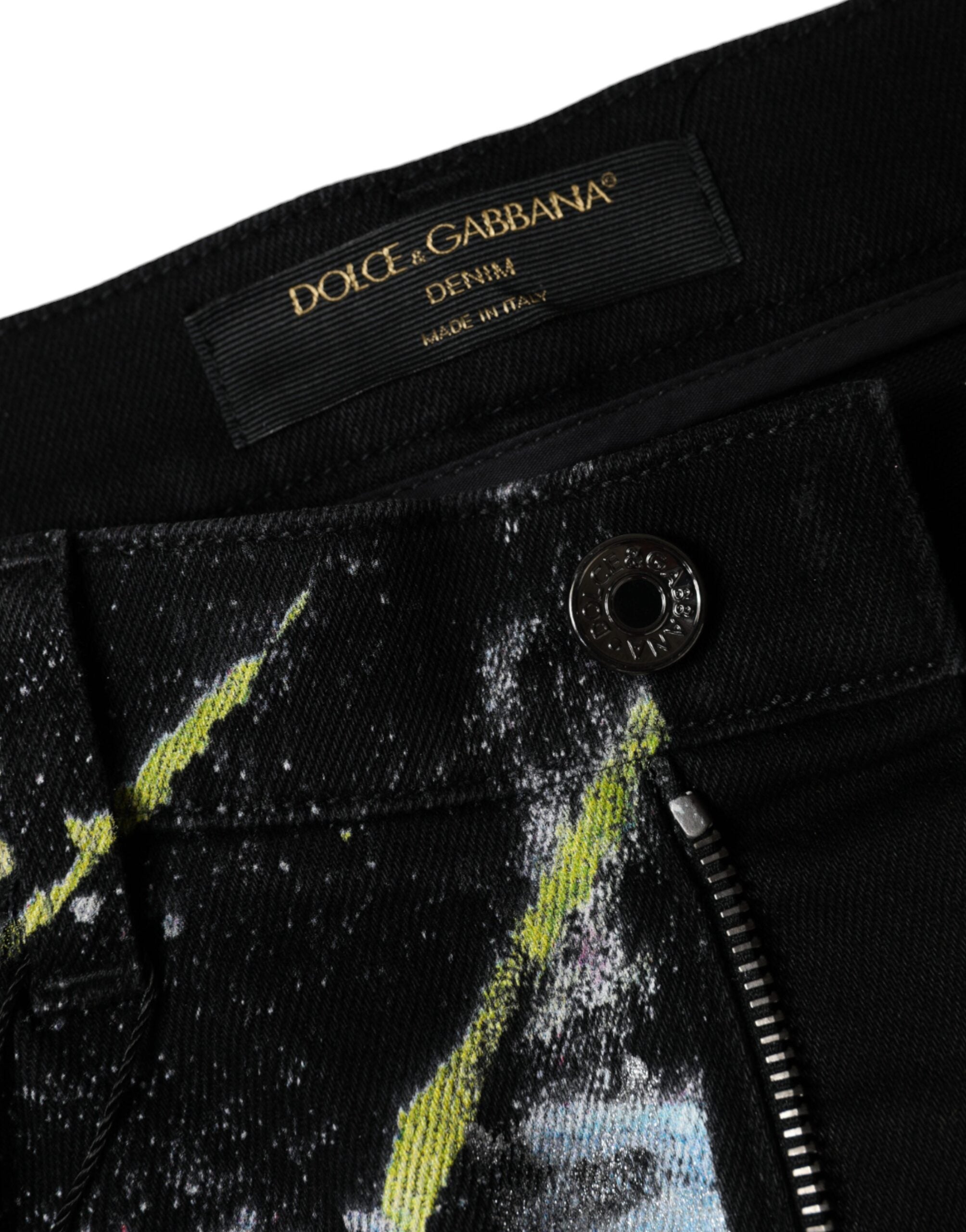 Multicolor splatter paint cotton skinny denim jeans by Dolce & Gabbana, showing vibrant paint splashes on classic blue denim.