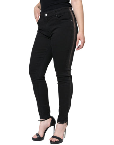 Black cotton stretch skinny denim jeans by Dolce & Gabbana, close-up showing fitted style and classic denim texture.