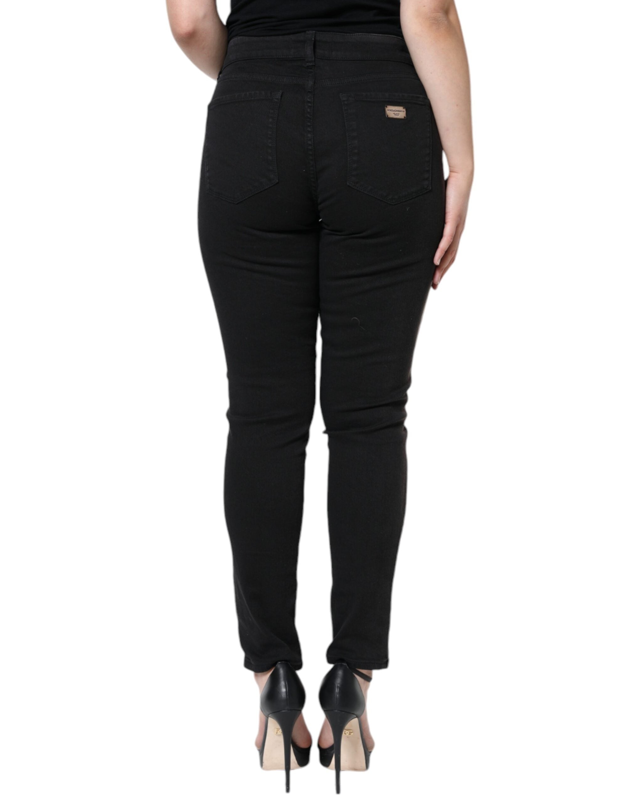 Black cotton stretch skinny denim jeans by Dolce & Gabbana, close-up of fitted jeans with classic five-pocket design.