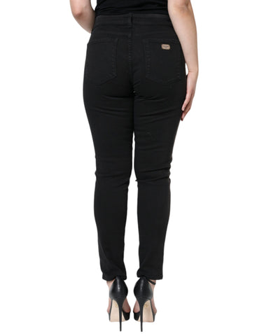 Black cotton stretch skinny denim jeans by Dolce & Gabbana, close-up of fitted jeans with classic five-pocket design.