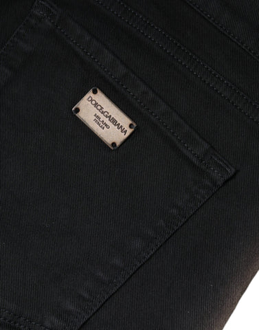 Black cotton stretch skinny denim jeans by Dolce & Gabbana, close-up of fitted style and classic five-pocket design.