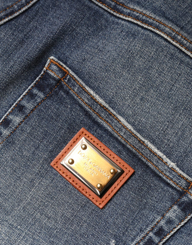 Dark blue cotton tattered skinny denim jeans by Dolce & Gabbana, showing distressed details and fitted silhouette.