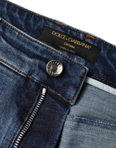 Dark blue cotton tattered skinny denim jeans by Dolce & Gabbana, showing distressed details and slim fit style.