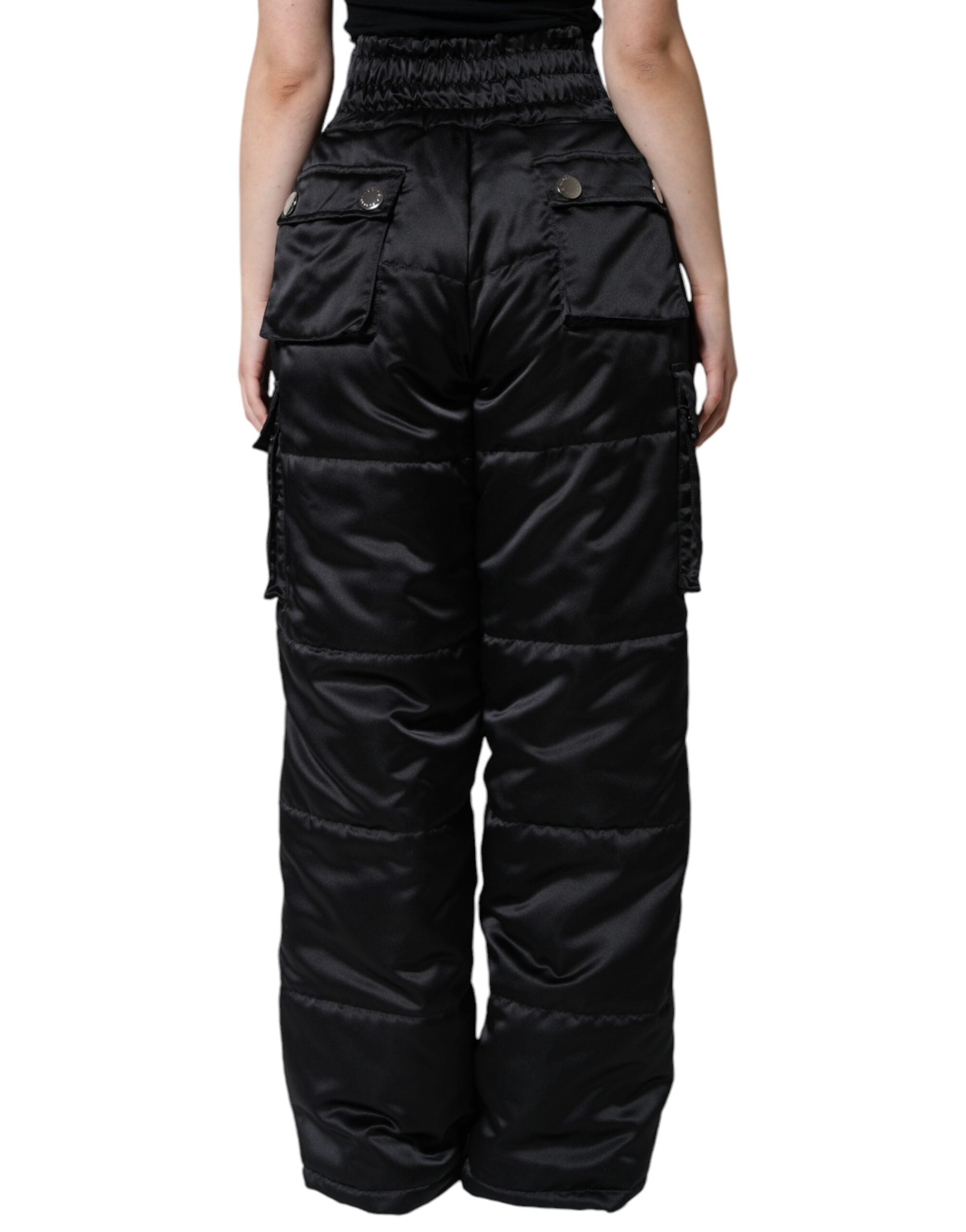 Black quilted high waist women’s boot cut pants by Dolce & Gabbana, shown on a model, with detailed quilting and tailored fit.