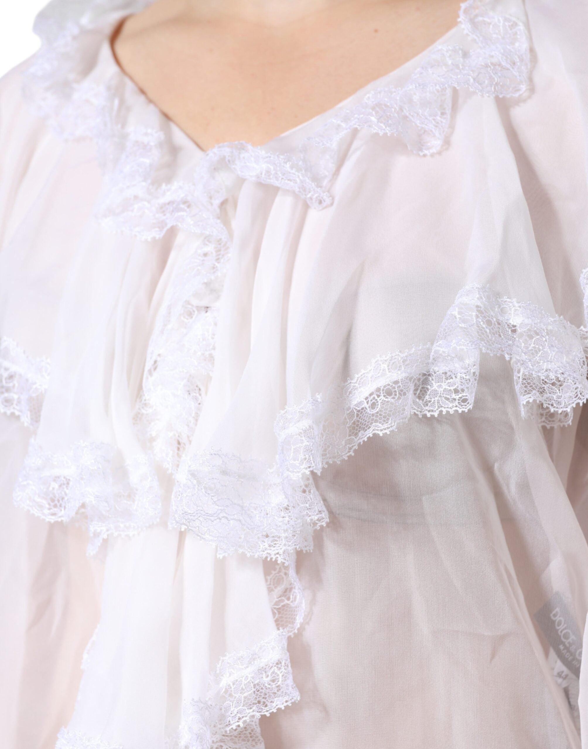 White lace long sleeve blouse with ruffles from Dolce & Gabbana, featuring intricate lace details and a feminine design.