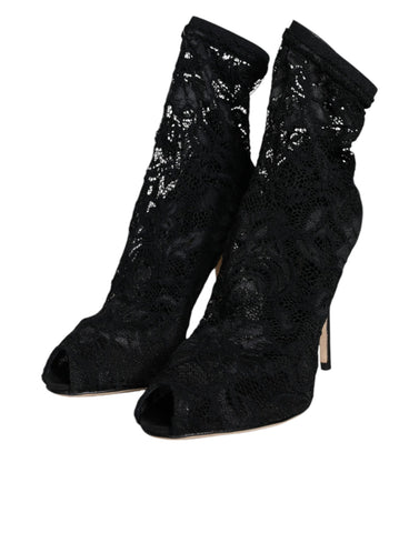 Black lace stretch mid-calf heel boots by Dolce & Gabbana with pointed toes and elegant lace details.