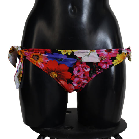 Black floral print Dolce & Gabbana bikini bottom with high-cut design and adjustable side ties for stylish swimwear.