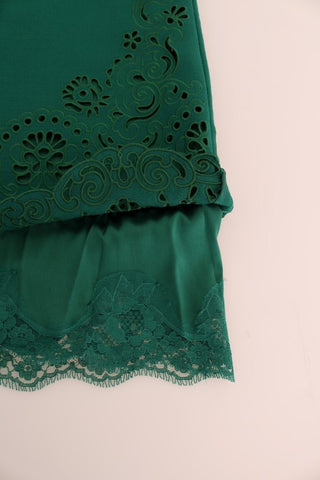 Green floral cutout silk wool dress by Dolce & Gabbana, showing intricate floral patterns and elegant cutout details.