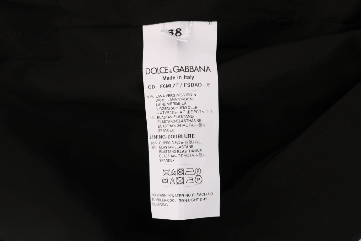 Gray polka dotted wool stretch dress by Dolce & Gabbana hanging on a clothing rack.