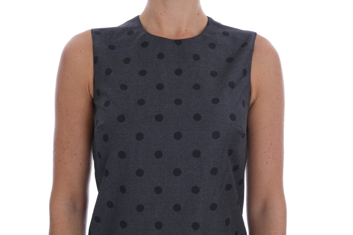 Gray polka dotted sheath wool dress by Dolce & Gabbana displayed on a hanger with a neutral background.