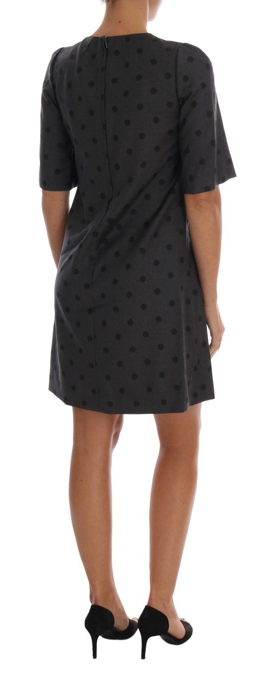 Gray polka dotted sheath wool dress by Dolce & Gabbana, close-up of the fitted dress with polka dot pattern and elegant design