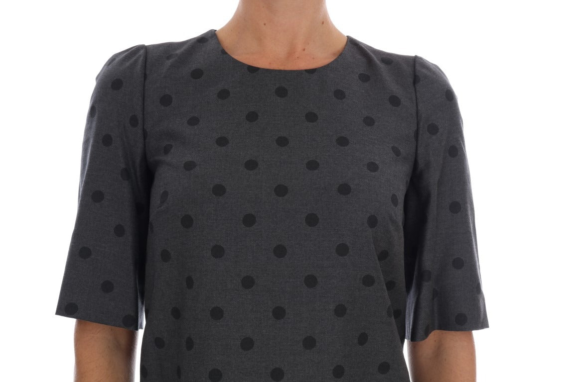 Gray polka dotted wool sheath dress by Dolce & Gabbana, close-up of fitted silhouette and classic pattern.