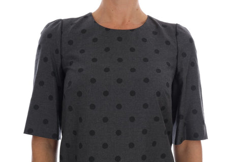 Gray polka dotted wool sheath dress by Dolce & Gabbana, close-up of fitted silhouette and classic pattern.