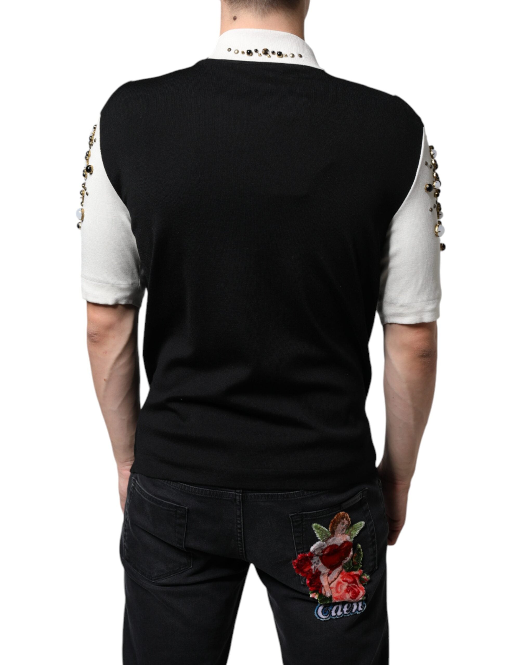 White silk shirt with black studded stones and crystal embellishments by Dolce & Gabbana, shown on a hanger.