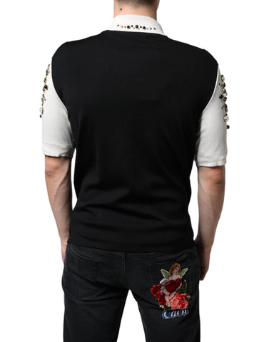 White silk shirt with black studded stones and crystal embellishments by Dolce & Gabbana, shown on a hanger.