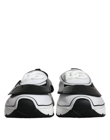 White and black Dolce & Gabbana Daymaster sneakers with logo plaque, featuring stylish design and comfortable athletic fit.