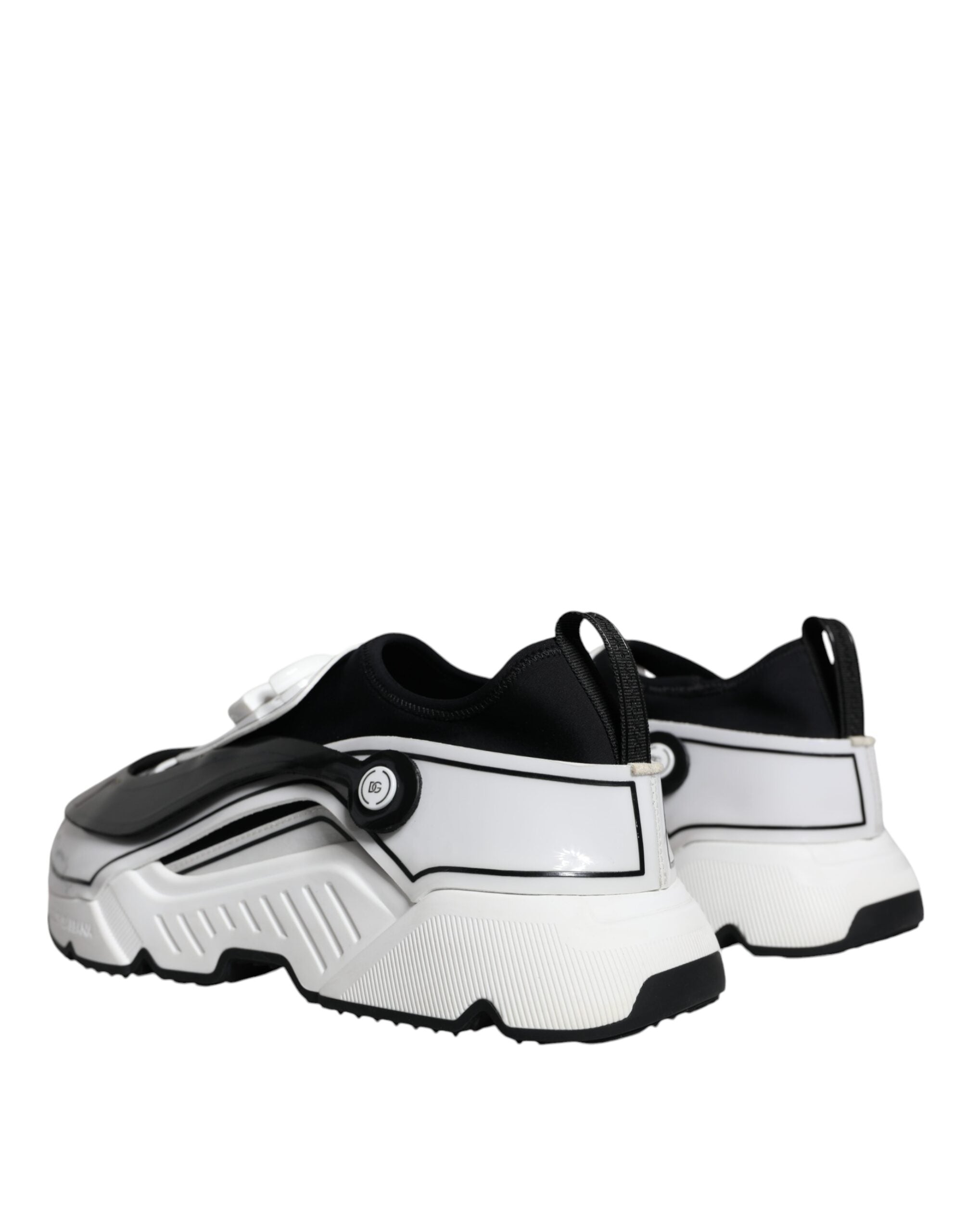 White and black Dolce & Gabbana Daymaster sneakers with logo plaque, showcasing stylish casual shoe design.
