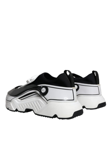 White and black Dolce & Gabbana Daymaster sneakers with logo plaque, showcasing stylish casual shoe design.